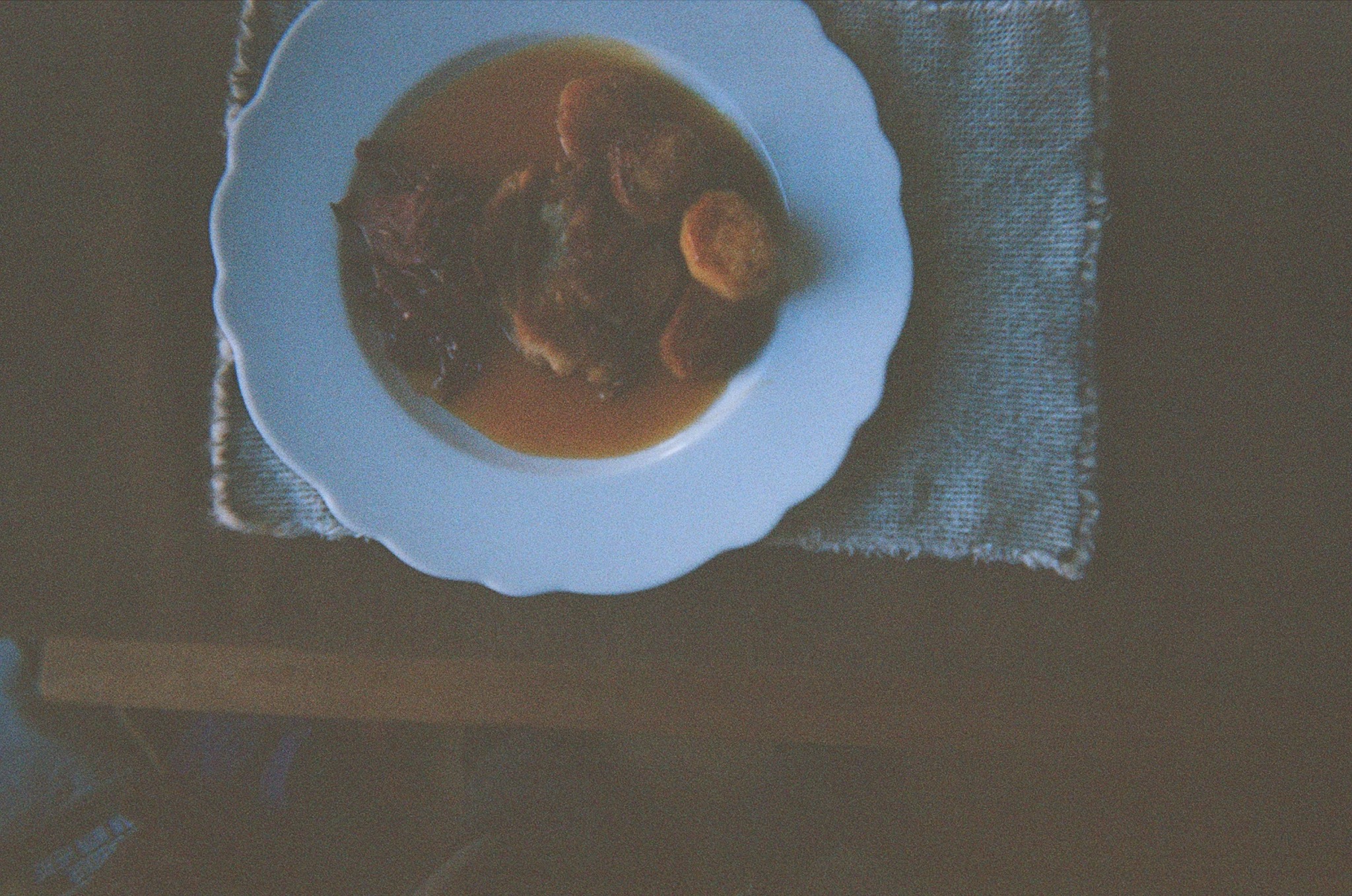 A dark stew on a white plate
